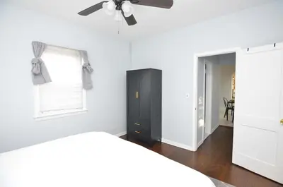 a bedroom with a bed and a ceiling fan at Spacious Home with Parking, Laundry - Near RU, RWJ, NJ Transit in Highland Park