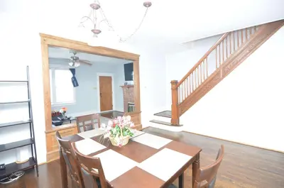 a dining room with a table and a staircase at Spacious Home with Parking, Laundry - Near RU, RWJ, NJ Transit in Highland Park