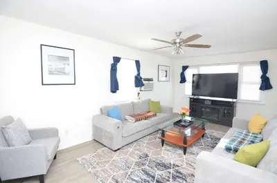 a living room with two couches and a flat screen tv at Spacious Home with Parking, Laundry - Near RU, RWJ, NJ Transit in Highland Park