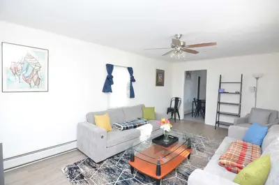 a living room with a couch and a table at Spacious Home with Parking, Laundry - Near RU, RWJ, NJ Transit in Highland Park