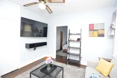 a living room with a couch and a table at Cozy Beds with Parking, Laundry - Near RU, RWJ, NJ Transit in Highland Park