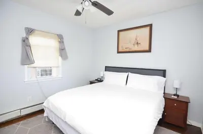 a bedroom with a white bed and a window at Cozy Beds with Parking, Laundry - Near RU, RWJ, NJ Transit in Highland Park