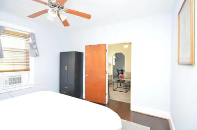 a living room with a ceiling fan and a door at Cozy Beds with Parking, Laundry - Near RU, RWJ, NJ Transit in Highland Park