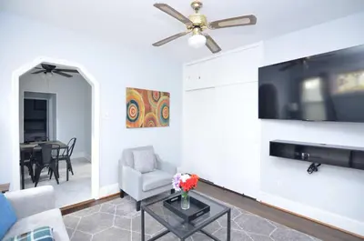 a living room with a couch and a ceiling fan at Cozy Beds with Parking, Laundry - Near RU, RWJ, NJ Transit in Highland Park