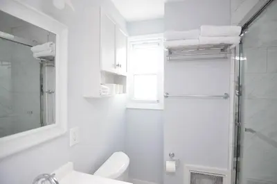 a bathroom with a shower and a toilet and a sink at Cozy Beds with Parking, Laundry - Near RU, RWJ, NJ Transit in Highland Park