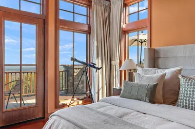 a bedroom with a bed and a window with a view at Pinnacle Pointe by Relaxtay 600 Acre Private Luxury Estate with Spa, Pool, Theater and Lake in Middletown