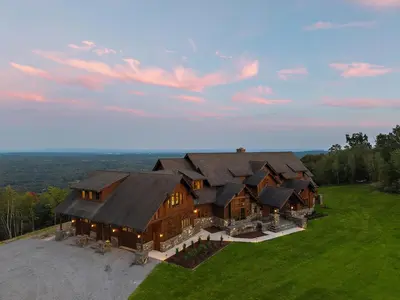 an aerial view of a large wooden house at Pinnacle Pointe by Relaxtay 600 Acre Private Luxury Estate with Spa, Pool, Theater and Lake in Middletown