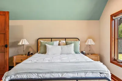 a bedroom with a bed with two night stands at Pinnacle Pointe by Relaxtay 600 Acre Private Luxury Estate with Spa, Pool, Theater and Lake in Middletown