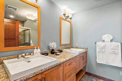 a bathroom with a sink and a mirror at Pinnacle Pointe by Relaxtay 600 Acre Private Luxury Estate with Spa, Pool, Theater and Lake in Middletown