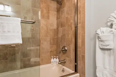 a bathroom with a shower and a sink at Pinnacle Pointe by Relaxtay 600 Acre Private Luxury Estate with Spa, Pool, Theater and Lake in Middletown