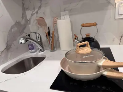 a pot on top of a counter next to a sink at Room with Kitchen in Chelsea - Shared Bathroom - 3rd Floor Walk-UP in New York