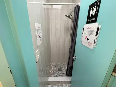 a bathroom with a shower with a glass door at Room with Kitchen in Chelsea - Shared Bathroom - 3rd Floor Walk-UP in New York