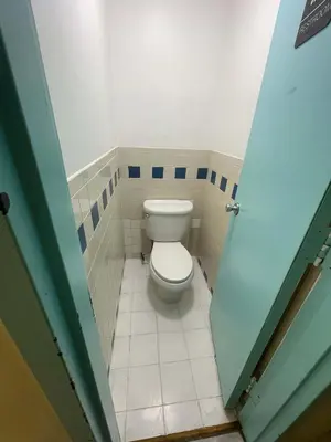 a bathroom with a toilet in a small room at Room with Kitchen in Chelsea - Shared Bathroom - 3rd Floor Walk-UP in New York