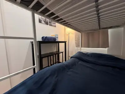 a bedroom with a large blue bed in a room at Room with Kitchen in Chelsea - Shared Bathroom - 3rd Floor Walk-UP in New York