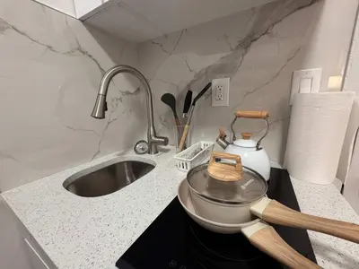 a kitchen counter with a pot and a sink at Room in Chelsea 2 with Kitchen - Shared Bathroom -5th Floor Walk-UP in New York
