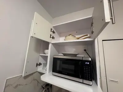 a microwave oven sitting on a counter in a kitchen at Room in Chelsea 2 with Kitchen - Shared Bathroom -5th Floor Walk-UP in New York