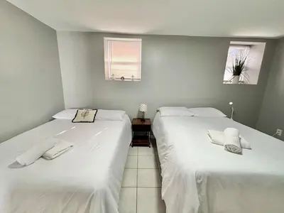 two beds sitting next to each other in a room at FREE Parking near NYC Washer and Dryer in North Bergen