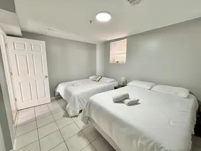 a bedroom with two beds and a white door at FREE Parking near NYC Washer and Dryer in North Bergen