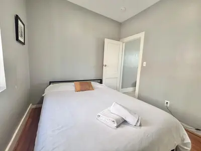 a bedroom with a bed with two towels on it at FREE Parking near NYC Washer and Dryer in North Bergen