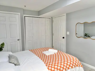 a bedroom with a bed with a mirror on the wall at FREE Parking near NYC Washer and Dryer in North Bergen