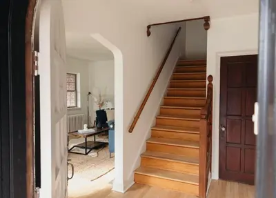 a staircase in a house with a wooden door at Lady Grey Cottage - Hot Tub in Conestoga
