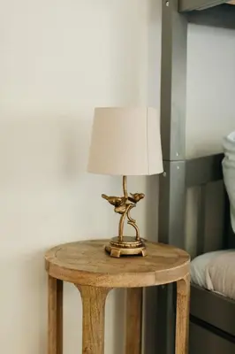 a small table with a lamp on top of it at Lady Grey Cottage - Hot Tub in Conestoga