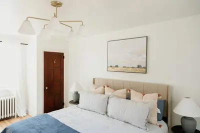 a bedroom with a bed with pillows on it at Lady Grey Cottage - Hot Tub in Conestoga