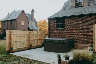 a backyard with a fence and a house at Conestoga Cottage with Hot Tub in Conestoga
