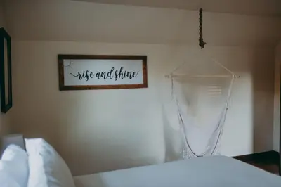 a bedroom with a bed and a sign on the wall at Conestoga Cottage with Hot Tub in Conestoga