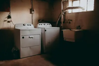a small kitchen with a stove and a sink at Conestoga Cottage with Hot Tub in Conestoga