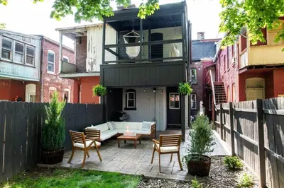 a backyard patio with a couch and chairs at The Lancastrian House Downtown in Lancaster