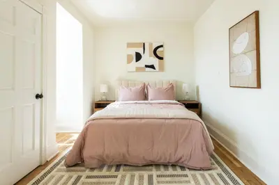 a bedroom with a bed with a pink bedspread at The Lancastrian House Downtown in Lancaster