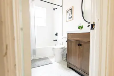 a bathroom with a toilet and a sink and a mirror at The Lancastrian House Downtown in Lancaster