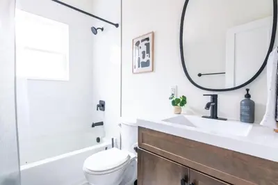 a bathroom with a sink and a toilet and a mirror at The Lancastrian House Downtown in Lancaster