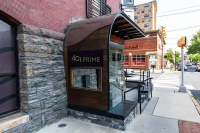 a store front with a sign on the side of a building at The Lancastrian House Downtown in Lancaster