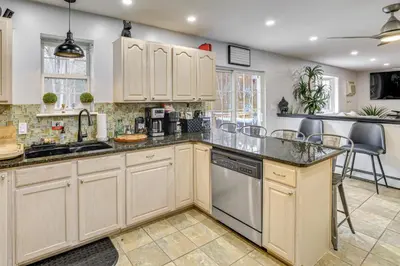 a kitchen with white cabinets and a counter top at 7 Mi to Slopes Family Getaway in Stroudsburg in Stroudsburg