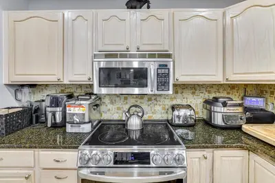 a kitchen with a stove and a microwave at 7 Mi to Slopes Family Getaway in Stroudsburg in Stroudsburg
