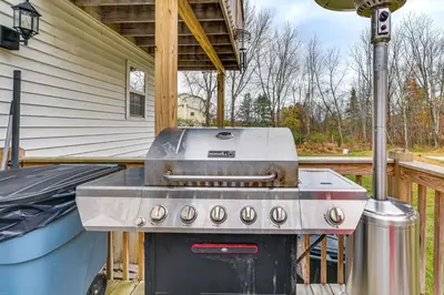 a grill on a deck with a house at 7 Mi to Slopes Family Getaway in Stroudsburg in Stroudsburg