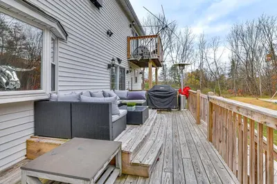 a patio with a couch and a table on a deck at 7 Mi to Slopes Family Getaway in Stroudsburg in Stroudsburg