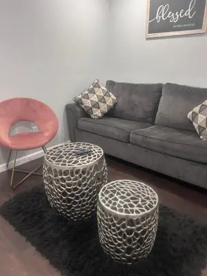 a living room with a couch and two circular stools at So cute so cozy in Elizabeth