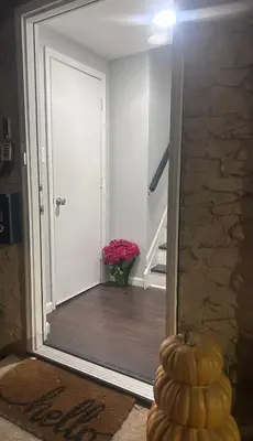 a hallway with a door and a vase of flowers at So cute so cozy in Elizabeth