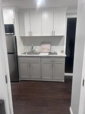a kitchen with white cabinets and a sink at So cute so cozy in Elizabeth