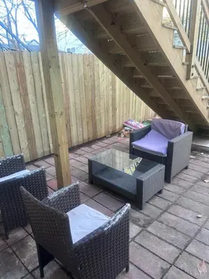 a patio with wicker chairs and a glass table at So cute so cozy in Elizabeth