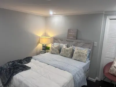 a bedroom with a large bed with white sheets and pillows at So cute so cozy in Elizabeth
