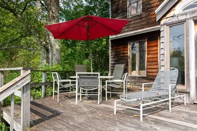 a patio with a table and chairs and an umbrella at Bootleg Hollow in Andes