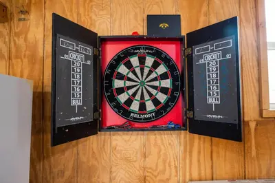 a dart board on a wall with three speakers at Relaxing Pocono Stay Near Lake with Hot Tub & BBQ in Blakeslee