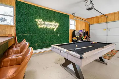a ping pong table in a room with a green wall at Relaxing Pocono Stay Near Lake with Hot Tub & BBQ in Blakeslee