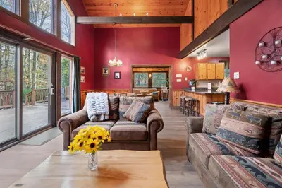 a living room with a couch and a table at Relaxing Pocono Stay Near Lake with Hot Tub & BBQ in Blakeslee
