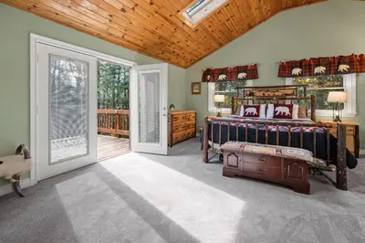 a bedroom with a bed and a wooden ceiling at Relaxing Pocono Stay Near Lake with Hot Tub & BBQ in Blakeslee