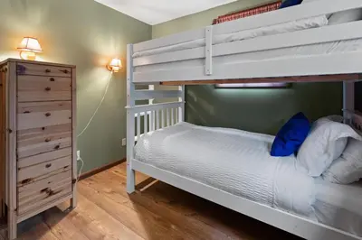 a bedroom with a bunk bed and a dresser at Relaxing Pocono Stay Near Lake with Hot Tub & BBQ in Blakeslee